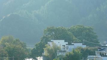 The beautiful traditional Chinese village view with the classical architecture and fresh green trees as background photo