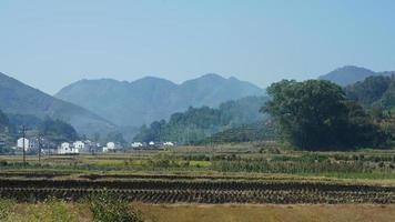 The beautiful traditional Chinese village view with the classical architecture and fresh green trees as background photo