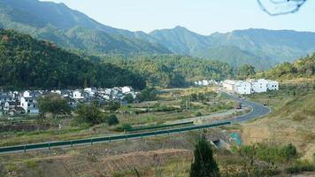 The beautiful traditional Chinese village view with the classical architecture and fresh green trees as background photo