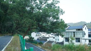 The beautiful traditional Chinese village view with the classical architecture and fresh green trees as background photo