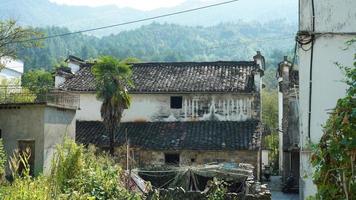 The beautiful traditional Chinese village view with the classical architecture and fresh green trees as background photo