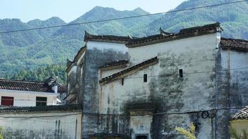 The beautiful traditional Chinese village view with the classical architecture and fresh green trees as background photo