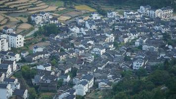 The beautiful traditional Chinese village view with the classical architecture and fresh green trees as background photo