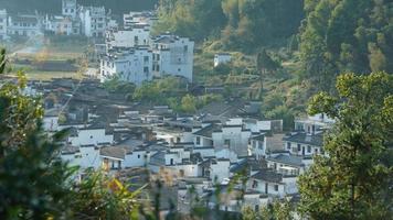 The beautiful traditional Chinese village view with the classical architecture and fresh green trees as background photo