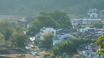 The beautiful traditional Chinese village view with the classical architecture and fresh green trees as background photo