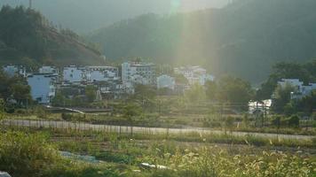 The beautiful traditional Chinese village view with the classical architecture and fresh green trees as background photo