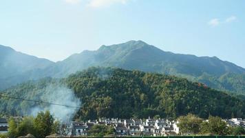 The beautiful traditional Chinese village view with the classical architecture and fresh green trees as background photo