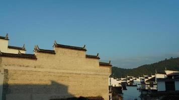 The beautiful traditional Chinese village view with the classical architecture and fresh green trees as background photo