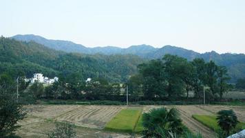 The beautiful traditional Chinese village view with the classical architecture and fresh green trees as background photo