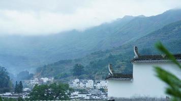 The beautiful traditional Chinese village view with the classical architecture and fresh green trees as background photo