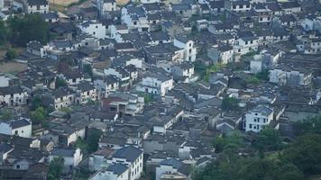 The beautiful traditional Chinese village view with the classical architecture and fresh green trees as background photo