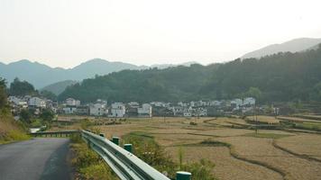 The beautiful traditional Chinese village view with the classical architecture and fresh green trees as background photo