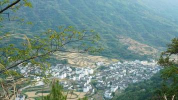 The beautiful traditional Chinese village view with the classical architecture and fresh green trees as background photo