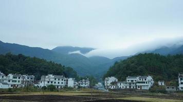 The beautiful traditional Chinese village view with the classical architecture and fresh green trees as background photo