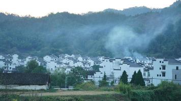 The beautiful traditional Chinese village view with the classical architecture and fresh green trees as background photo