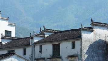 The beautiful traditional Chinese village view with the classical architecture and fresh green trees as background photo