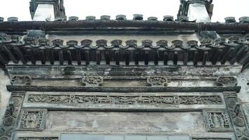 The old wooden Chinese house carved with the beautiful sculpture in the countryside village of the China photo