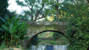 The old arched stone bridge view located in the countryside of the China photo