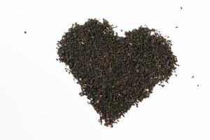 Black tea heart on white background. photo