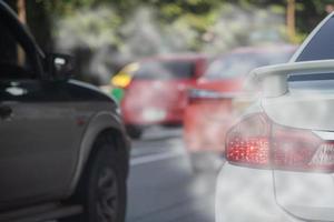 Air pollution from car exhaust smoke traffic in the city. Reducing global warming pollution and carbon dioxide from engine combustion. photo