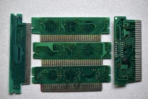 Old electronic boards for retro games. Cartridges for retro game consoles. photo