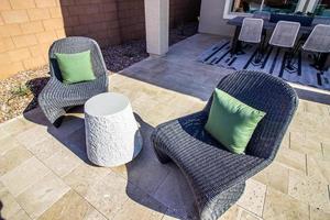 Two Grey Wicker Chairs On Back Patio photo