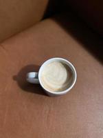 cup of coffee on wooden table photo