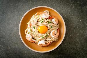 spaghetti white cream sauce with shrimps and egg yolk photo