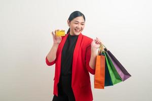 Asian woman holding shopping bag and credit card photo