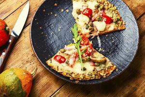 Pizza on pumpkin flatbread photo