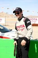 LOS ANGELES, MAR 23 - Jackson Rathbone playing with a old racing wheel at the 37th Annual Toyota Pro Celebrity Race training at the Willow Springs International Speedway on March 23, 2013 in Rosamond, CA   EXCLUSIVE PHOTO