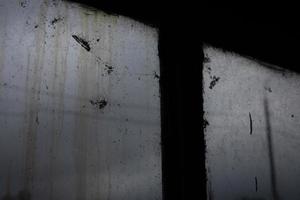 Old window on grey day. Cloudy weather outside window. Gloomy interior. photo