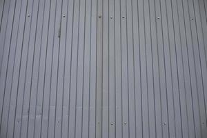 Grey steel wall. Steel profile with stiffeners. Metal cladding on house. photo