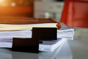 paperwork and book on white table photo