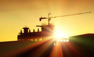 silhouette construction site in sunset photo