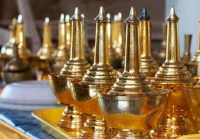 row of golden flagons on tray photo