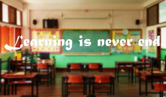 education quote over blurred classroom photo