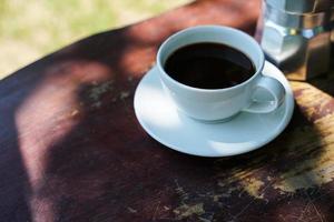 Hot black coffee in a white cup,coffee is a popular beverage all over the world. photo