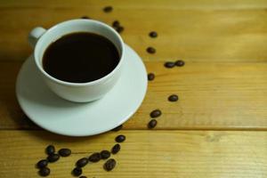 Hot black coffee in a white cup,coffee is a popular beverage all over the world. photo