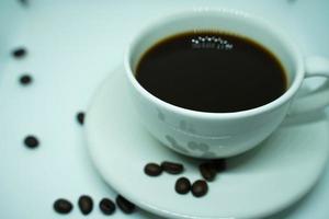Hot black coffee in a white cup,coffee is a popular beverage all over the world. photo