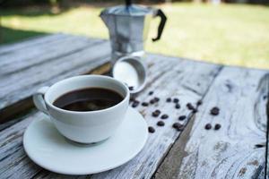 Hot black coffee in a white cup,coffee is a popular beverage all over the world. photo