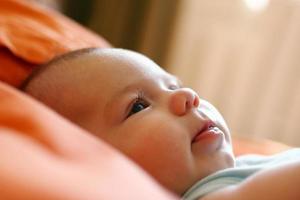 Portrait of child on a bed in a morning time in backlight. photo