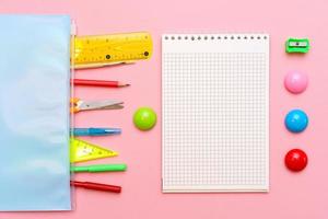 School notebook and various office supplies. Back to school concept photo