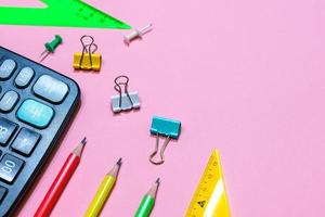 School supplies on a pink background. View from above. Copy space. photo