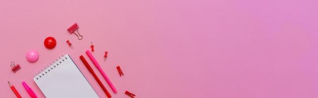 Stationery in pastel pink shades. On a pink background, flat lay. Markers photo