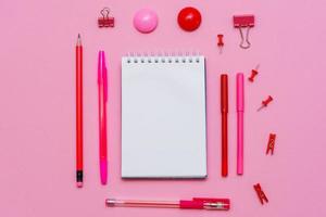 Stationery in pastel pink shades. On a pink background, flat lay. Markers photo