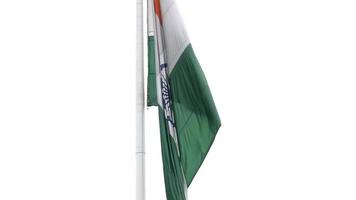 India flag flying high at Connaught Place with pride in blue sky, India flag fluttering, Indian Flag on Independence Day and Republic Day of India, tilt up shot, Waving Indian flag, Har Ghar Tiranga video