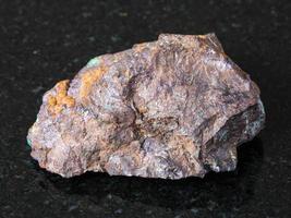 Cuprite and Malachite in Limonite rock on dark photo