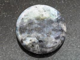 bead from gray Labradorite gemstone on dark photo