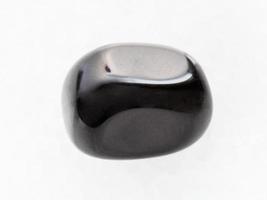 polished black Onyx gemstone on white marble photo